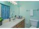 Bright bathroom features a sink, a mirror with lighting, and a bathtub with a shower curtain at 718 Wildwood Dr, Winter Springs, FL 32708