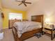 Spacious bedroom featuring a ceiling fan, carpet, window, and furniture at 718 Wildwood Dr, Winter Springs, FL 32708