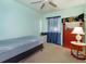 Comfortable bedroom with bed, carpet, window with curtains, and a ceiling fan at 718 Wildwood Dr, Winter Springs, FL 32708