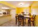 Bright dining room features yellow walls, tile floors, and a dining table with seating for four at 718 Wildwood Dr, Winter Springs, FL 32708
