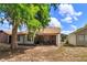 Back exterior of the house with a screened porch surrounded by large trees at 718 Wildwood Dr, Winter Springs, FL 32708