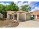 Charming single-story home featuring a carport, freshly painted exterior, and well-maintained landscaping in a quiet neighborhood at 718 Wildwood Dr, Winter Springs, FL 32708