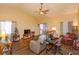 Comfortable living room featuring wood floors, neutral paint, ceiling fan and view of backyard at 718 Wildwood Dr, Winter Springs, FL 32708