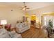 Cozy living room featuring wood floors, neutral paint, ceiling fan and open access to the dining area at 718 Wildwood Dr, Winter Springs, FL 32708