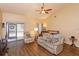 Bright living room features wood floors, neutral paint, ceiling fan and sliding doors to the backyard at 718 Wildwood Dr, Winter Springs, FL 32708