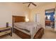 Comfortable main bedroom featuring carpet floors, ceiling fan, and access to en-suite bathroom at 718 Wildwood Dr, Winter Springs, FL 32708