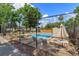 Inviting fenced pool area with lounge chairs and tables for relaxing by the water at 718 Wildwood Dr, Winter Springs, FL 32708