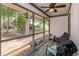 View of screen-in porch with a ceiling fan, plants, and chair overlooking backyard at 718 Wildwood Dr, Winter Springs, FL 32708