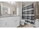 Bathroom featuring a vanity with ample storage, plus a tub with a stylish shower curtain at 7573 Laureate Blvd # 1-404, Orlando, FL 32827