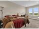 Bedroom with a large window provides great light and relaxing views to the beautiful outdoors at 7573 Laureate Blvd # 1-404, Orlando, FL 32827