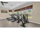 Community gym with treadmills, stationary bikes, and large windows providing natural light and pleasant views at 7573 Laureate Blvd # 1-404, Orlando, FL 32827