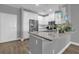 A modern kitchen features stone countertops, stainless appliances, and ample white cabinetry at 7573 Laureate Blvd # 1-404, Orlando, FL 32827