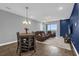 A living room is open and features hard surface floors, comfortable seating, and exterior views at 7573 Laureate Blvd # 1-404, Orlando, FL 32827