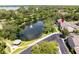 Aerial view of the property with a pond and fountain, surrounded by trees at 804 Challis Pt, Longwood, FL 32779