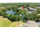 Beautiful aerial view of a pond with fountain and the multi-Gathering property surrounded by lush trees at 804 Challis Pt, Longwood, FL 32779