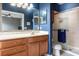 Bathroom features a vanity with wood cabinets and a shower with glass doors at 804 Challis Pt, Longwood, FL 32779
