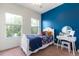 Bedroom with natural light from two windows and a blue accent wall at 804 Challis Pt, Longwood, FL 32779