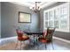 Formal dining room with tile floors, chandelier, and a window with plantation shutters at 804 Challis Pt, Longwood, FL 32779