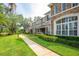 Attractive multi-story home with stone accents, a manicured lawn, and a sidewalk leading to the entrance at 804 Challis Pt, Longwood, FL 32779
