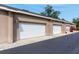 Attached garages with white doors and ample parking space on a smooth, paved driveway at 804 Challis Pt, Longwood, FL 32779