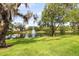 Scenic view of a pond with a fountain, surrounded by lush greenery at 804 Challis Pt, Longwood, FL 32779