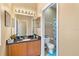 Well-lit bathroom with granite countertop, vanity with storage, and a separate toilet area for privacy at 822 Brunello Dr, Davenport, FL 33897