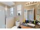Bright bathroom with a glass shower door, granite countertops, and a large mirror at 822 Brunello Dr, Davenport, FL 33897