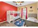 Themed bedroom with bunkbeds and twin bed is decorated with vibrant colors, a ceiling fan, and a themed rug at 822 Brunello Dr, Davenport, FL 33897