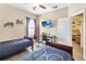 Bedroom with twin beds and a desk; it is decorated with themed decor, and a ceiling fan is visible at 822 Brunello Dr, Davenport, FL 33897