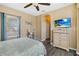 Comfortable bedroom with a ceiling fan, TV, and a window bringing in plenty of natural light at 822 Brunello Dr, Davenport, FL 33897