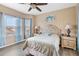 Serene bedroom with wood floor, soft blue accents, and natural light from two windows at 822 Brunello Dr, Davenport, FL 33897