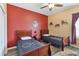 Inviting bedroom features matching twin beds, unique decor, and a ceiling fan for added comfort at 822 Brunello Dr, Davenport, FL 33897