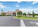Stunning community clubhouse featuring manicured landscaping, a fountain, and a circular drive at 822 Brunello Dr, Davenport, FL 33897