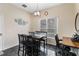 Traditional dining room featuring black marble floors, a dark wood table, and a view of the pool at 822 Brunello Dr, Davenport, FL 33897