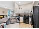Well-equipped kitchen with white cabinetry, a black appliance suite, and a breakfast bar at 822 Brunello Dr, Davenport, FL 33897