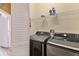 Well-organized laundry room with modern washer and dryer, shelves, and a folding door for added convenience at 822 Brunello Dr, Davenport, FL 33897