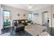 Comfortable living room with a leather sofa, decorative pillows, and a view of the backyard at 822 Brunello Dr, Davenport, FL 33897