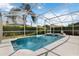Relaxing screened-in pool and spa area with lounge seating and tropical landscaping at 822 Brunello Dr, Davenport, FL 33897