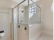 Walk-in shower features a frameless glass enclosure, tiled walls, and modern fixtures at 822 Brunello Dr, Davenport, FL 33897