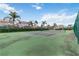 Well-maintained community tennis court surrounded by lush landscaping and palm trees at 822 Brunello Dr, Davenport, FL 33897