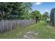 Wooden fence encloses a grassy backyard, with lush trees and landscaping providing privacy at 842 Amidon St, Deltona, FL 32725