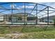 Beautiful backyard with a screened-in pool, mature landscaping, and a privacy fence at 842 Amidon St, Deltona, FL 32725