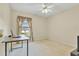 Cozy bedroom featuring neutral walls, carpet flooring, and a window with decorative curtains, complete with a ceiling fan at 842 Amidon St, Deltona, FL 32725