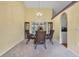Elegant dining area with a chandelier, ample natural light, and a view to the porch at 842 Amidon St, Deltona, FL 32725