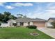 Charming single-story home boasts a well-manicured lawn, lovely landscaping, and a convenient two-car garage at 842 Amidon St, Deltona, FL 32725
