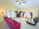 Bright living room with vaulted ceilings, neutral carpet, and a ceiling fan at 842 Amidon St, Deltona, FL 32725