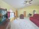 Spacious living room with vaulted ceilings, carpet, and comfortable seating at 842 Amidon St, Deltona, FL 32725