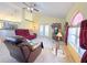 Living room with vaulted ceilings, ceiling fan, access to the kitchen and outdoor patio at 842 Amidon St, Deltona, FL 32725