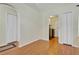Living area featuring wood floors with views to the laundry room and two closets, creating a seamless flow throughout the home at 842 Amidon St, Deltona, FL 32725