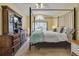 Cozy main bedroom with a four-poster bed, carpet floors, and dresser with TV, offering a relaxing retreat at 842 Amidon St, Deltona, FL 32725